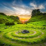 green grass field during sunset