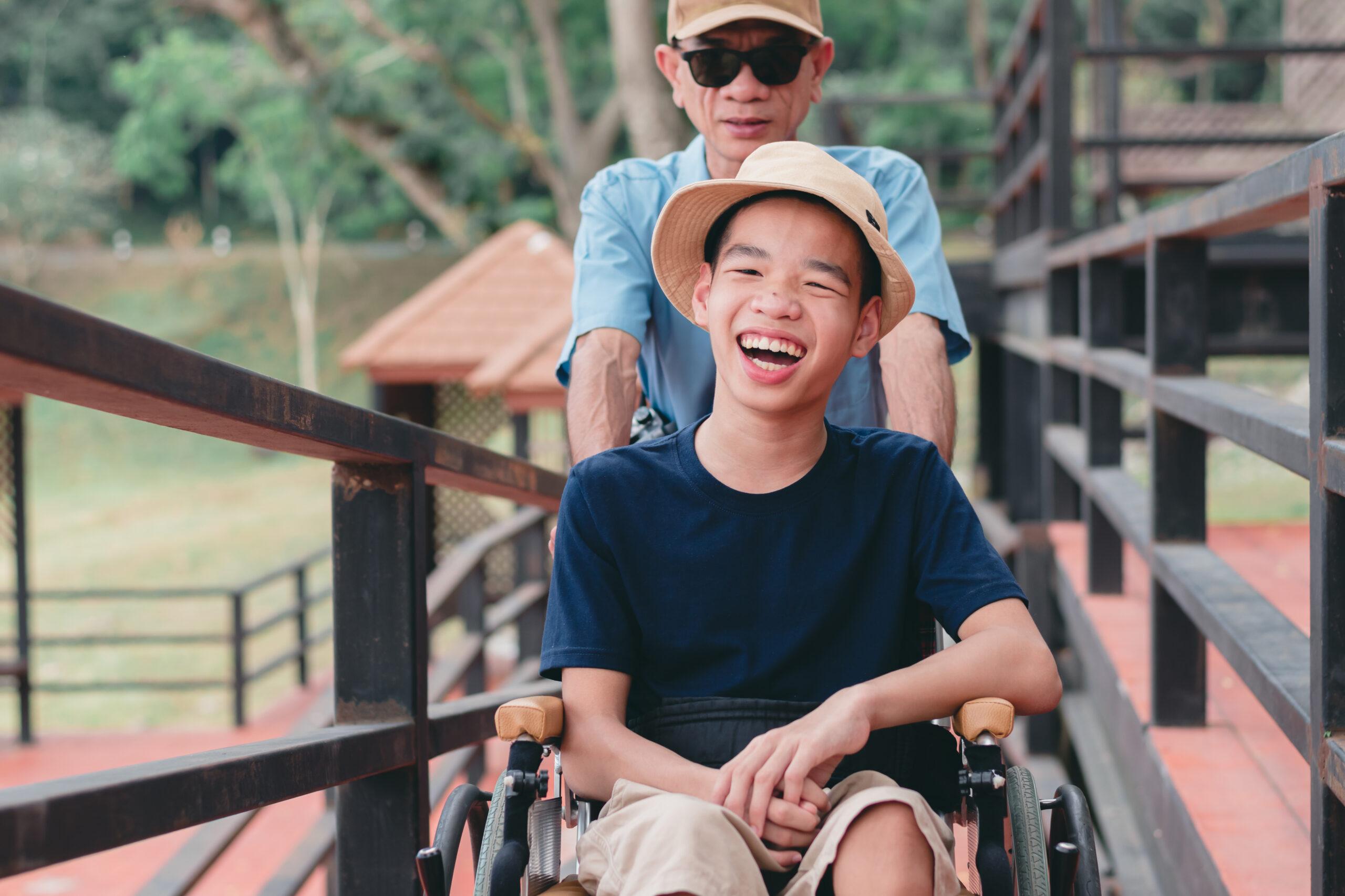 caregiver thumbs up with wheelchair elderly man